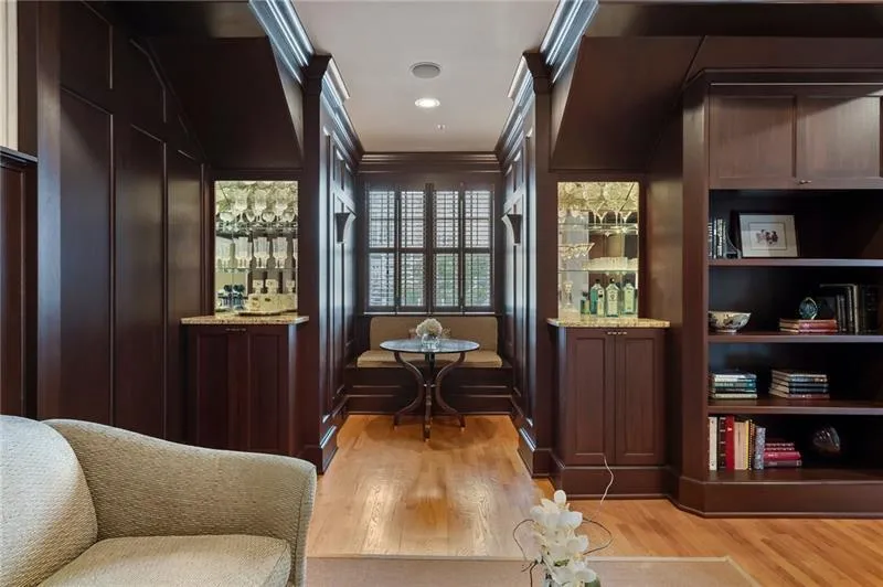 Living area with light wood-type flooring, ornamental molding, and recessed lighting