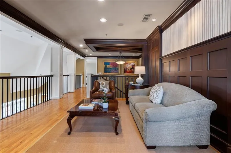 Living area featuring recessed lighting, light wood-style flooring, a decorative wall, visible vents, and crown molding