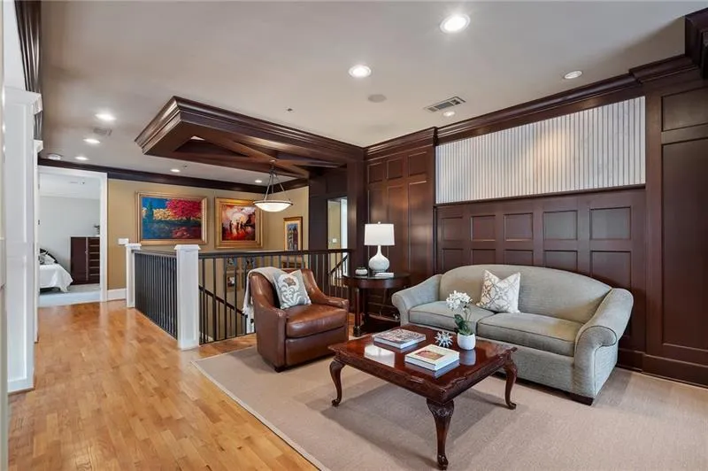 Living room with visible vents, ornamental molding, recessed lighting, and a decorative wall