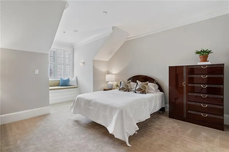 Bedroom featuring ornamental molding, lofted ceiling, light carpet, and baseboards