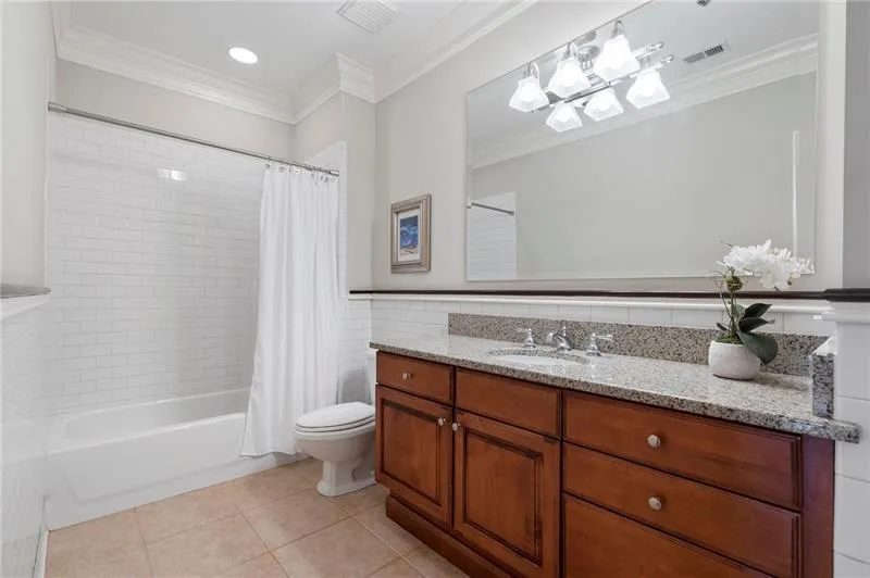 Bathroom with visible vents, ornamental molding, toilet, and tile patterned flooring