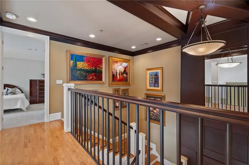 Hall featuring recessed lighting, light wood-style floors, an upstairs landing, baseboards, and crown molding