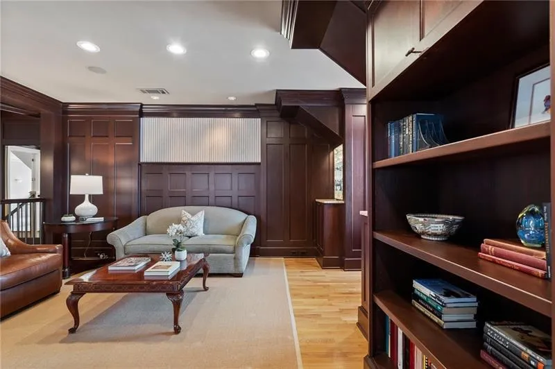Living room with visible vents, recessed lighting, light wood finished floors, and a decorative wall