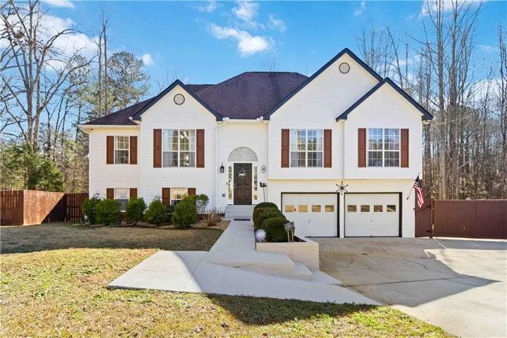 Split foyer home featuring driveway and an attached garage