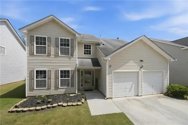 Two-story exterior with light-colored siding