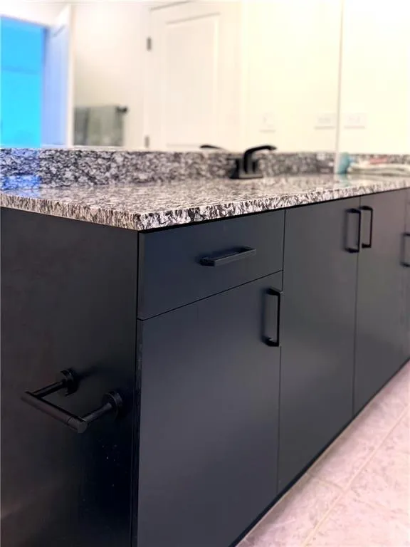 Bathroom featuring vanity and light tile patterned floors Bathroom featuring vanity and light tile patterned floors