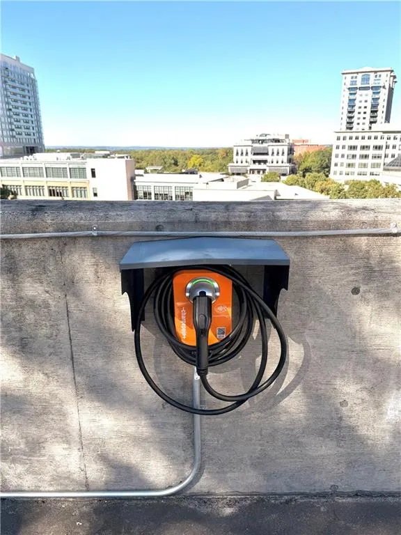 Exterior view of electric vehicle charger and a city view Exterior view of electric vehicle charger and a city view