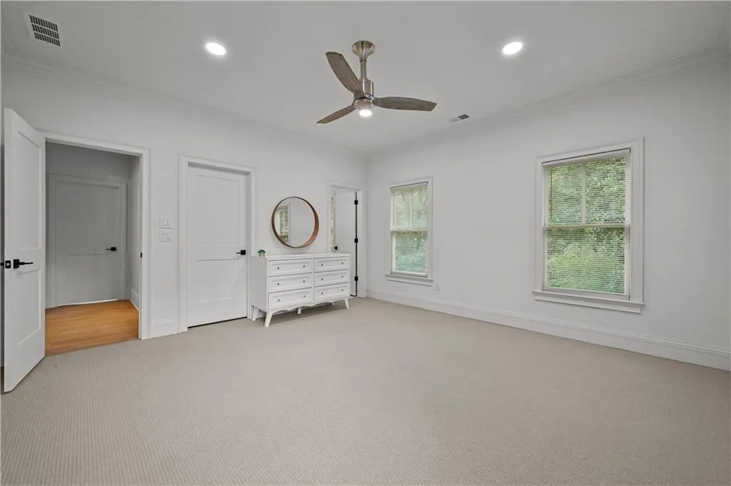 Unfurnished bedroom with ornamental molding, light colored carpet, recessed lighting, and ceiling fan