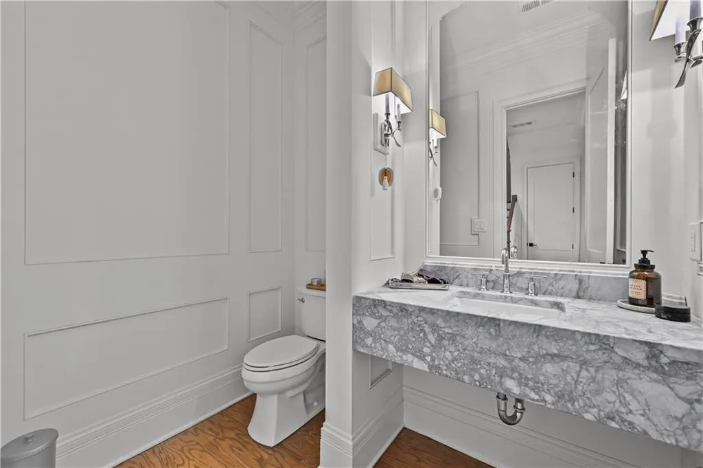 Bathroom featuring wood finished floors, crown molding, and vanity