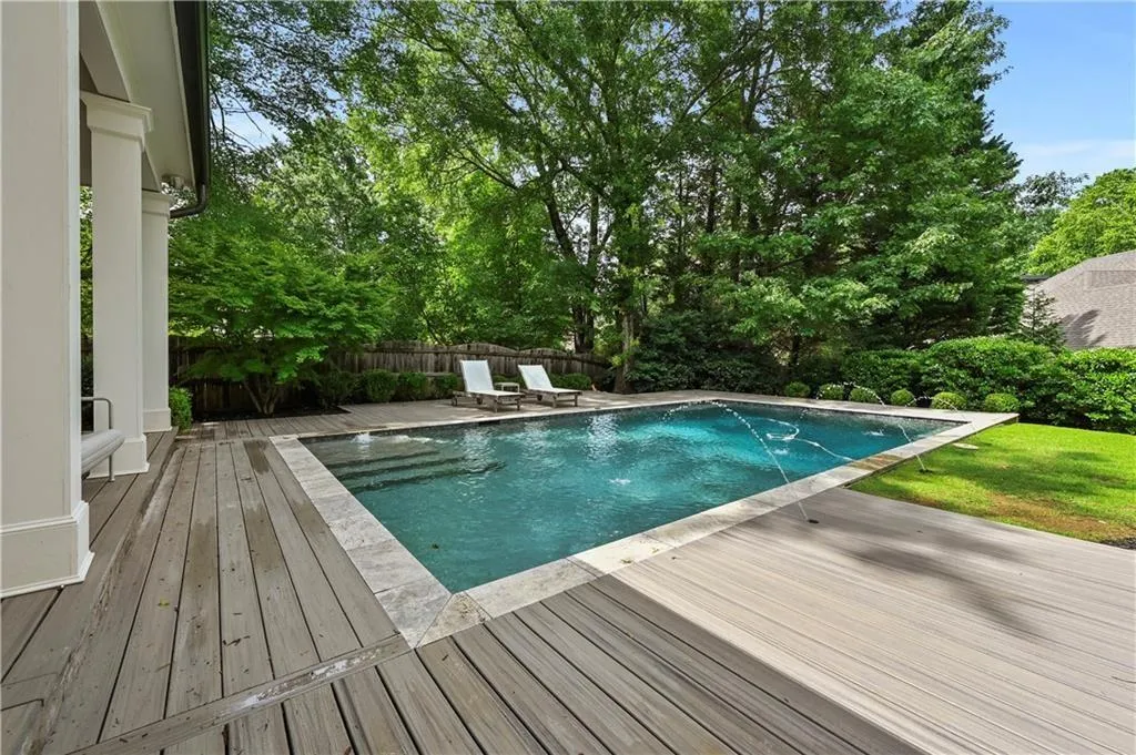 View of swimming pool featuring a deck and a fenced backyard