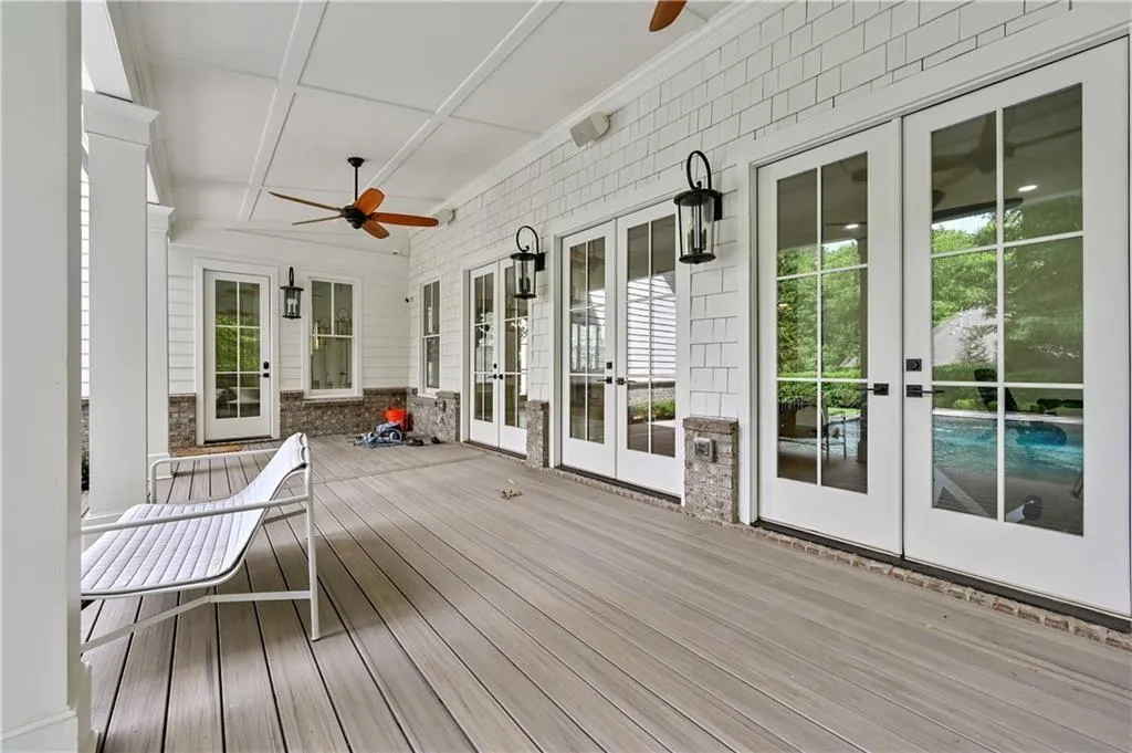 Deck with french doors and a ceiling fan