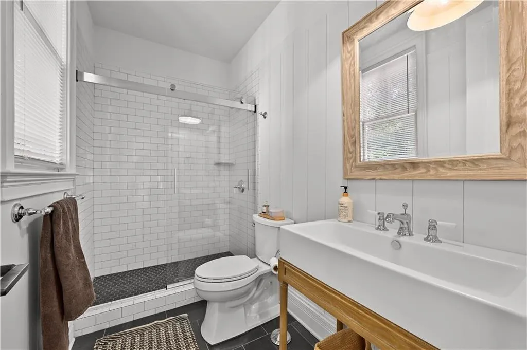 Bathroom featuring a shower stall, tile patterned flooring, and vanity
