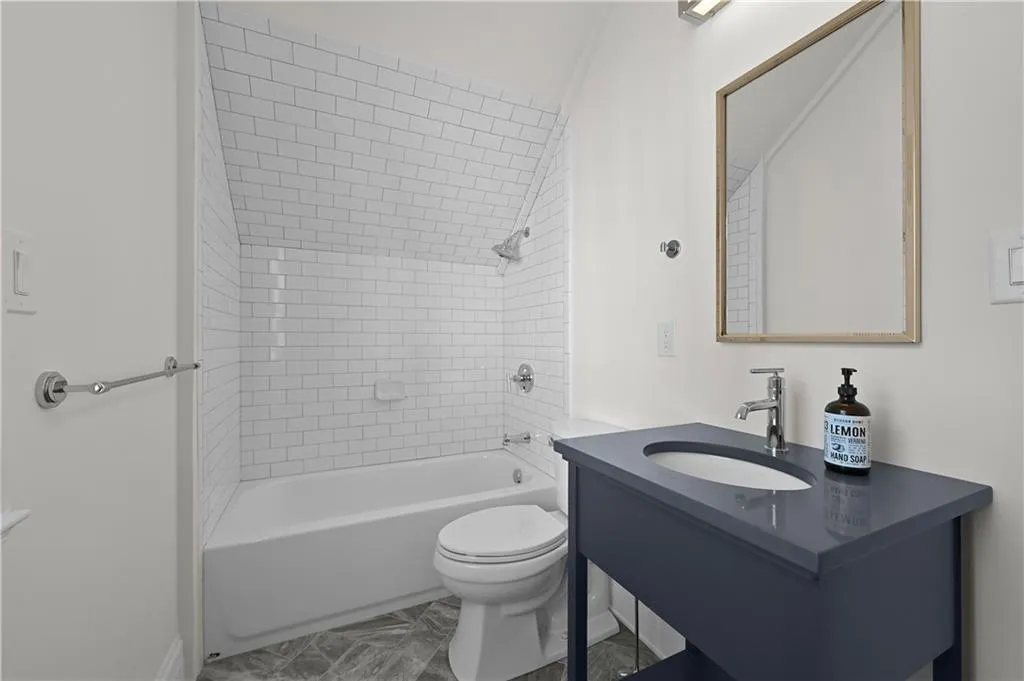 Full bath featuring vanity and shower / washtub combination