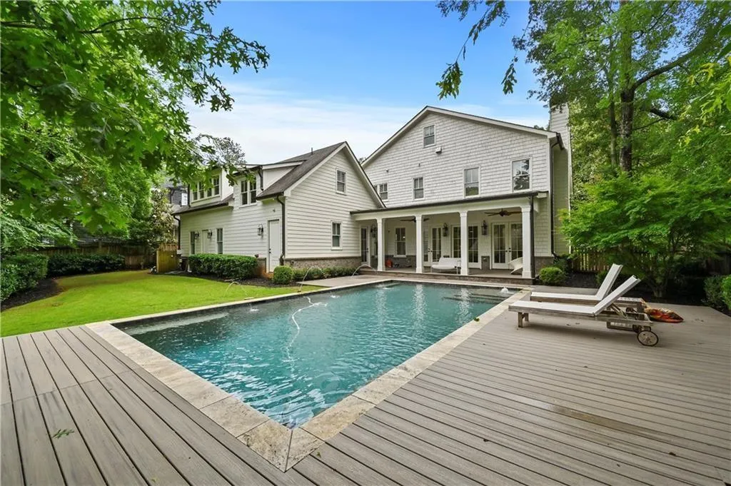 View of swimming pool featuring a wooden deck and a ceiling fan