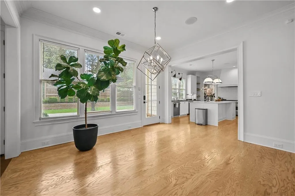 Unfurnished dining area with ornamental molding, light wood finished floors, recessed lighting, and a chandelier