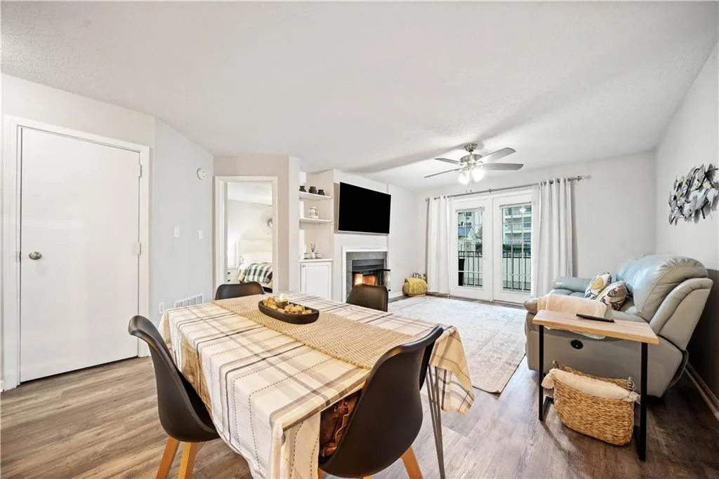 Dining space featuring ceiling fan, a textured ceiling, and light hardwood / wood-style floors