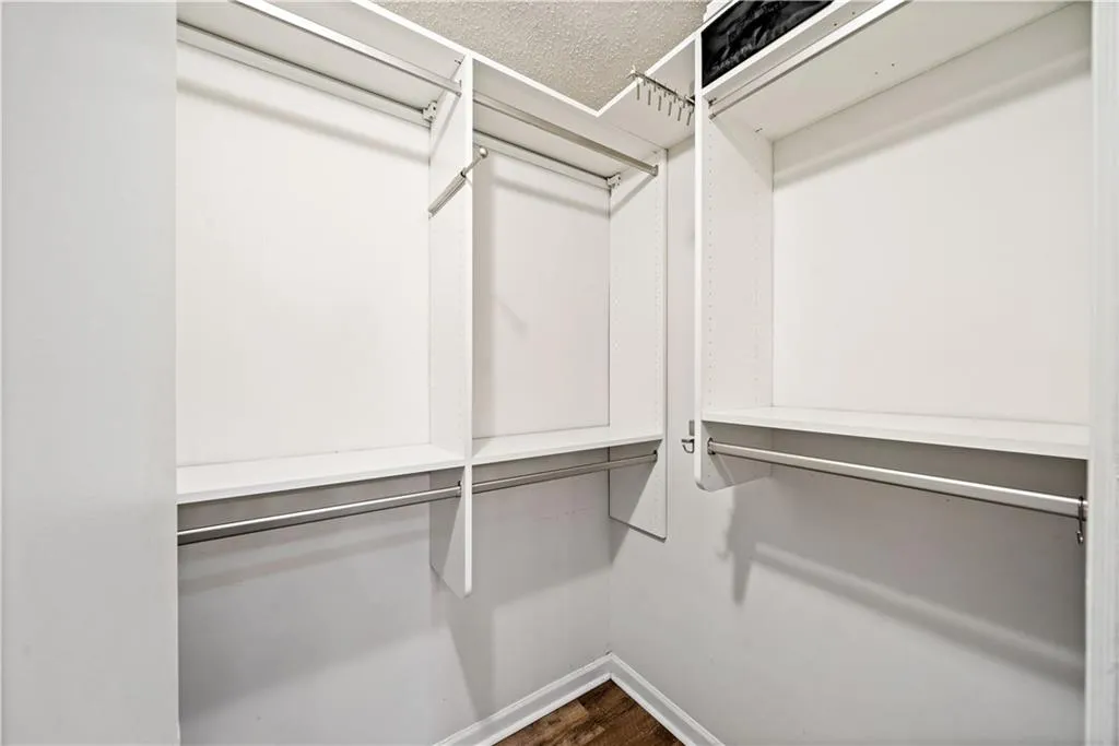 Spacious closet featuring hardwood / wood-style flooring