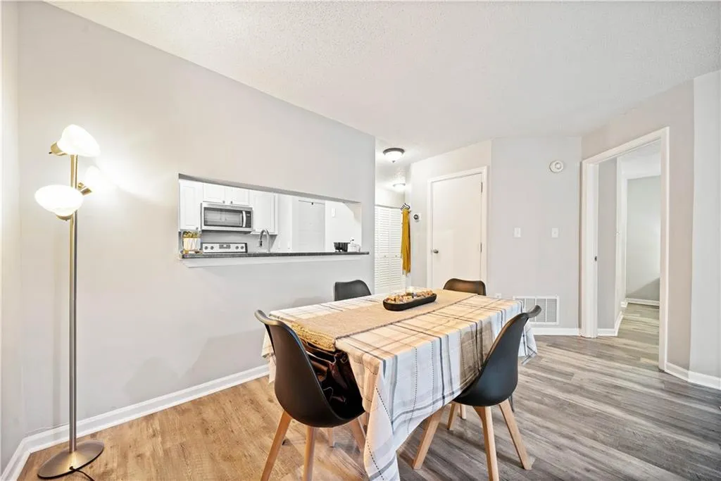 Dining space with light hardwood / wood-style floors and a textured ceiling