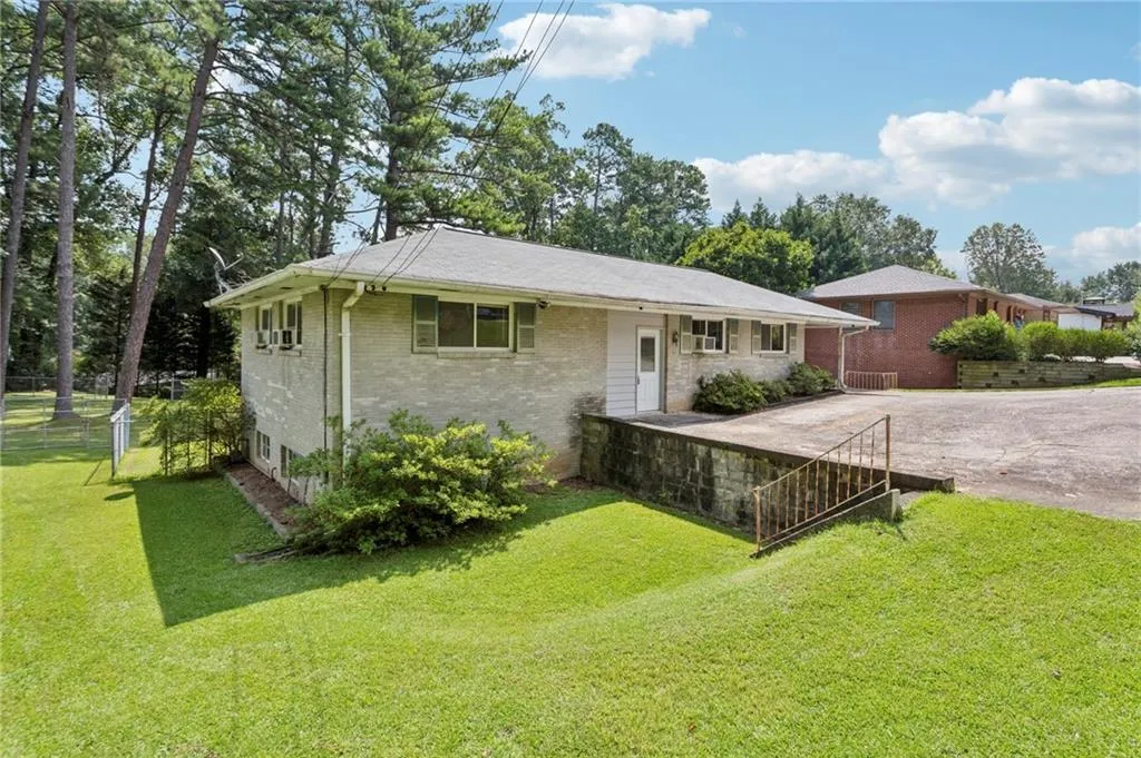 Single story home featuring brick siding and driveway