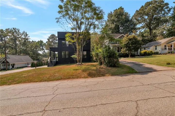 View of front of property with a front lawn and driveway