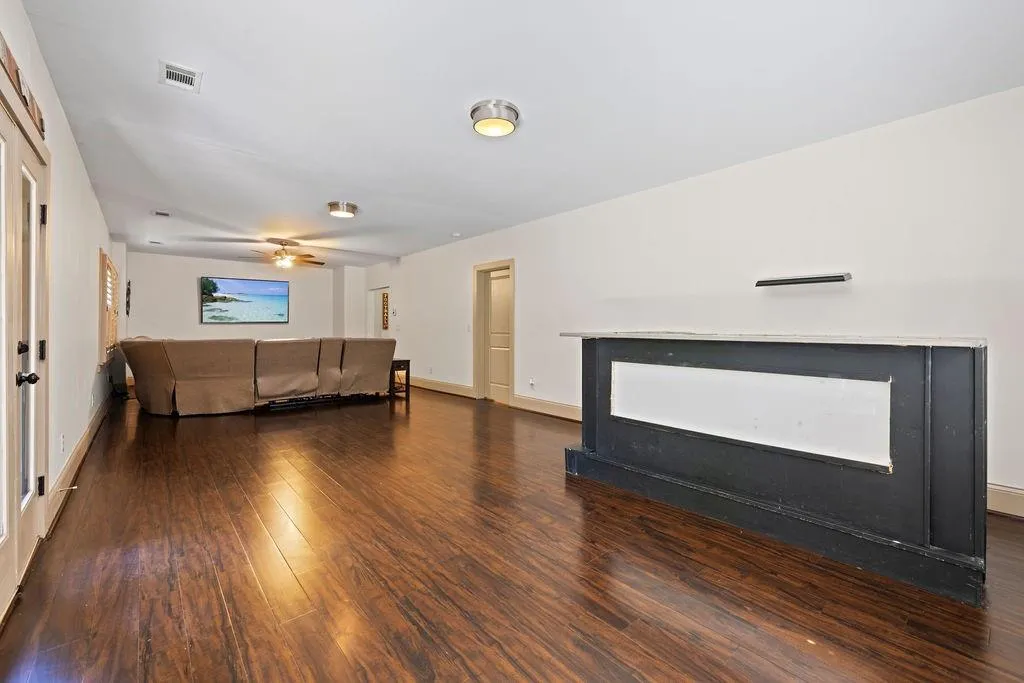 Unfurnished living room with a fireplace, hardwood / wood-style floors, and ceiling fan