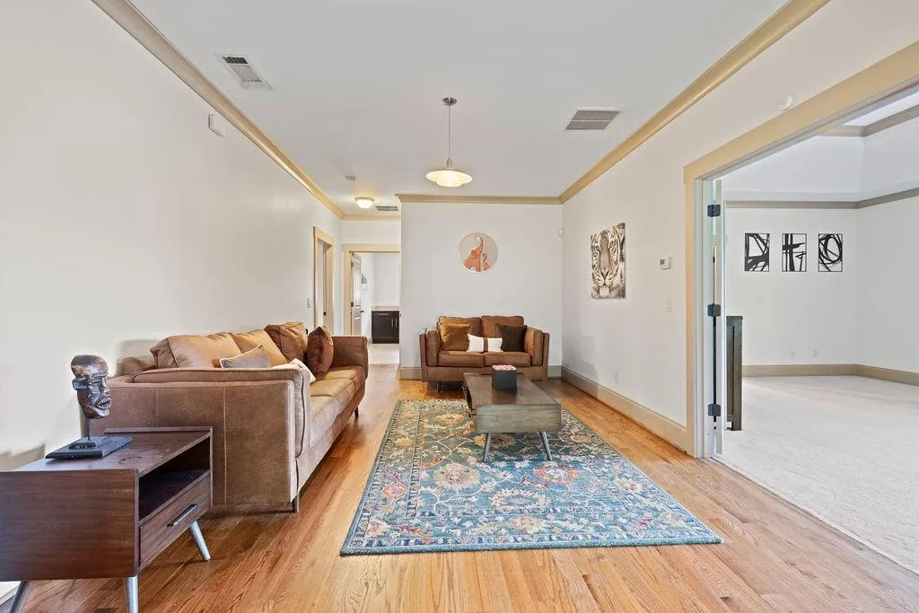 Living room featuring light hardwood / wood-style flooring and ornamental molding