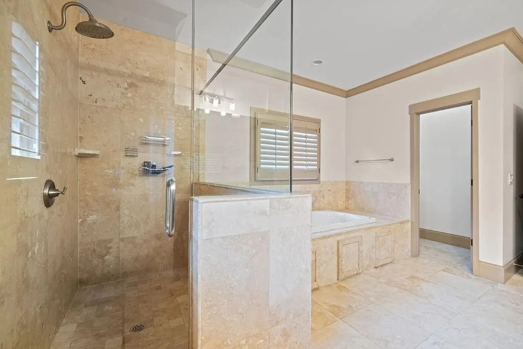 Bathroom with crown molding, tile patterned flooring, plus walk in shower, and a wealth of natural light