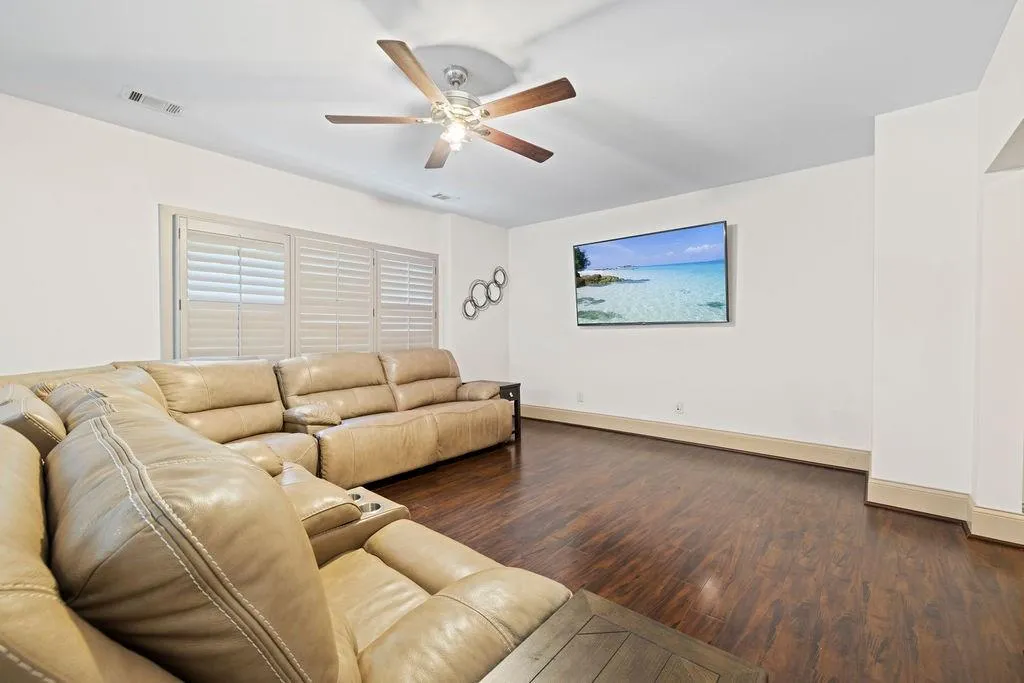 Living room featuring ceiling fan and hardwood / wood-style flooring
