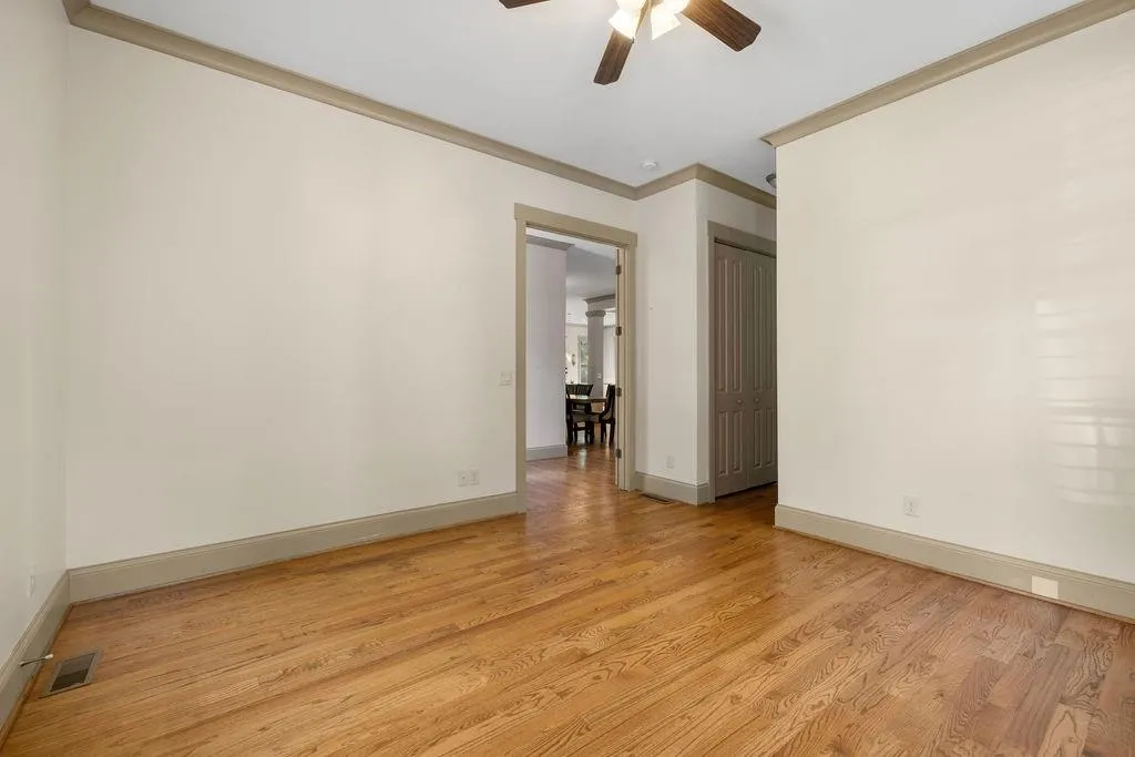 Unfurnished room with light hardwood / wood-style flooring, crown molding, and ceiling fan