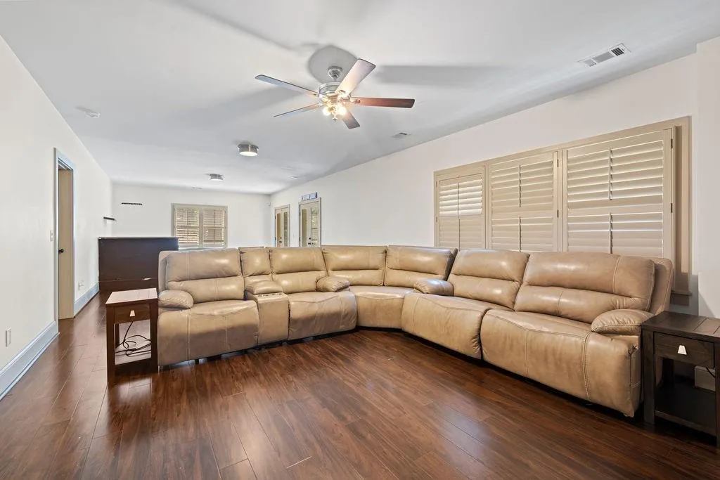 Living room featuring ceiling fan and hardwood / wood-style flooring