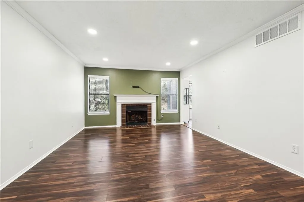 The family room shows off a cozy brick fireplace.