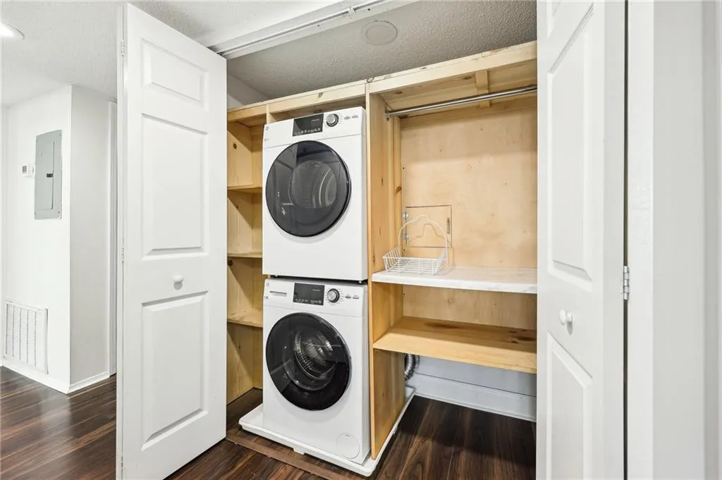 Washer and dryer included with custom shelving.