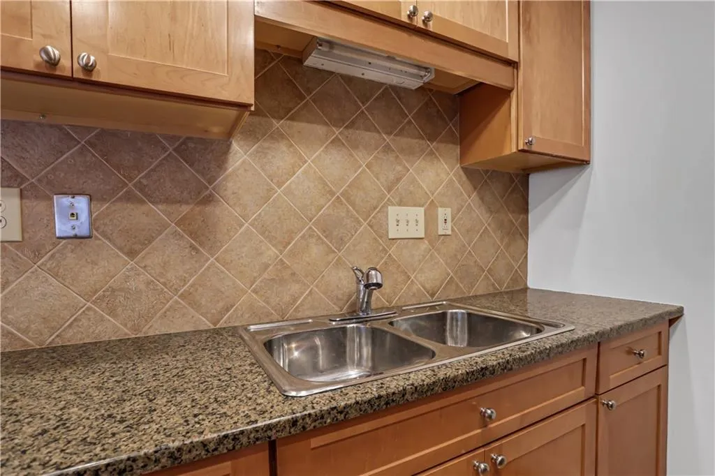 Kitchen featuring dark countertops and tasteful backsplash