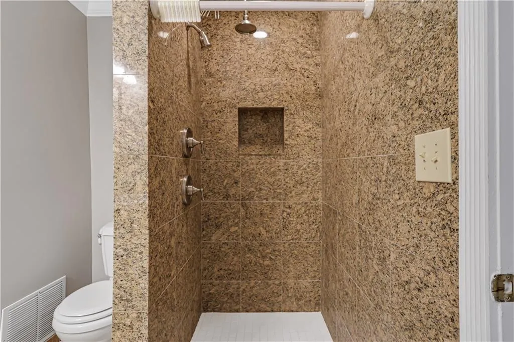 Bathroom with a tile shower and toilet