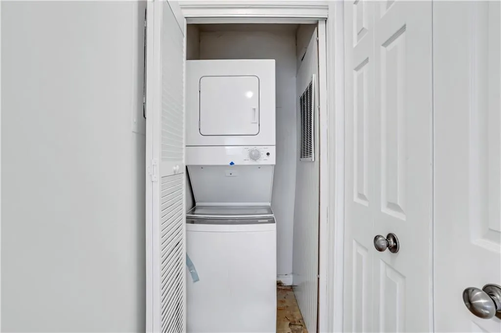 Washroom with stacked washing machine and dryer