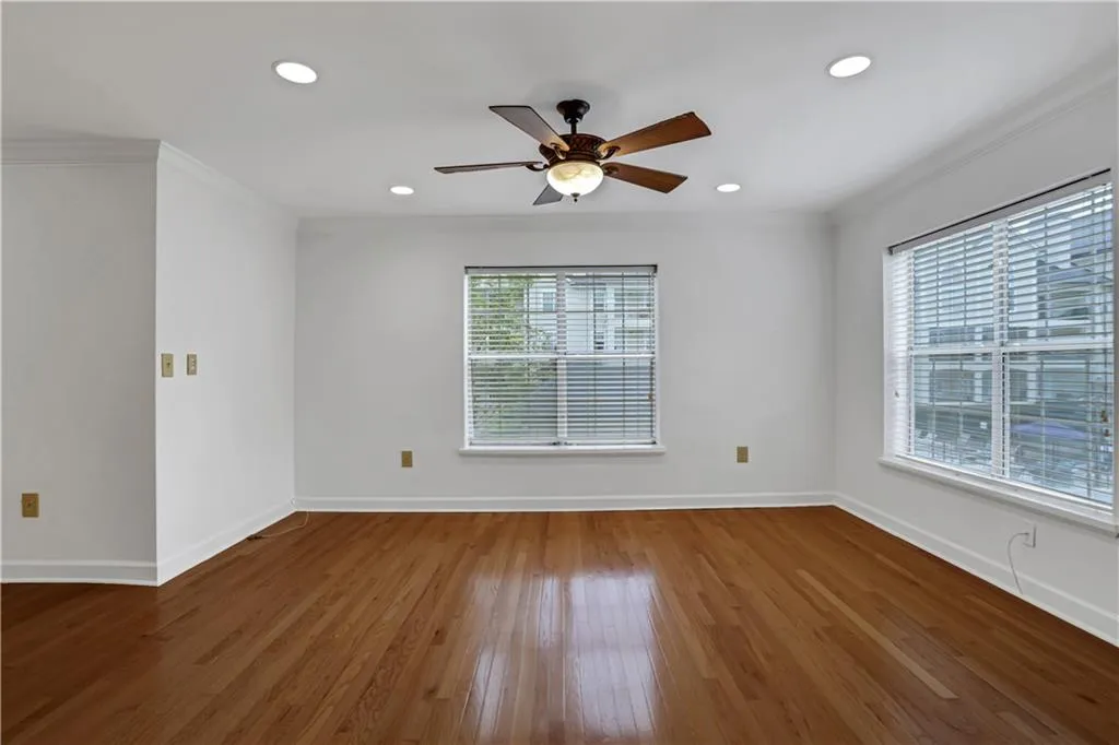 Unfurnished room featuring ornamental molding, wood-type flooring, a ceiling fan, and recessed lighting