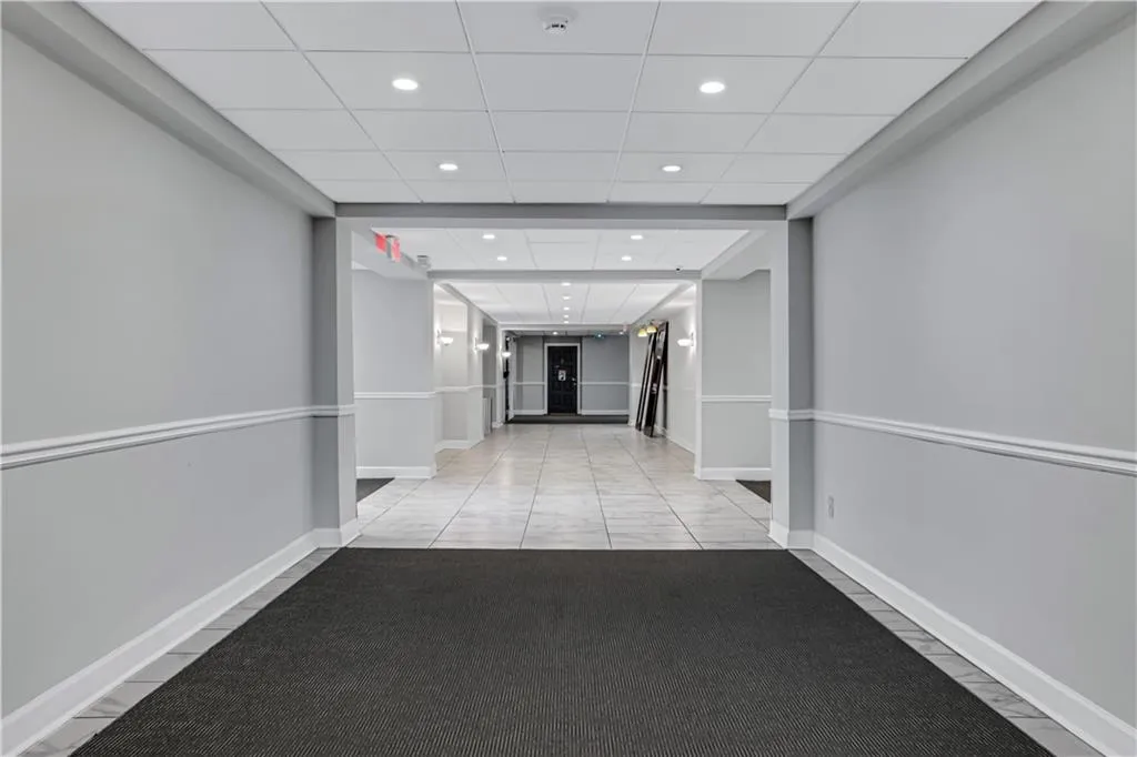 Hallway featuring recessed lighting, a drop ceiling, and tile patterned floors