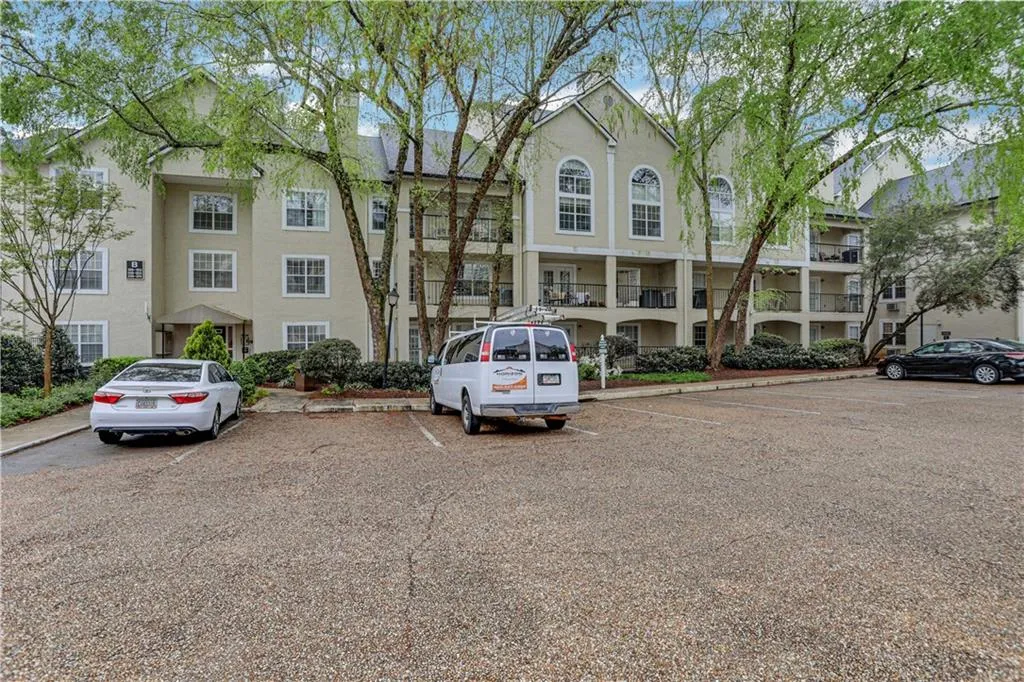 View of property with uncovered parking
