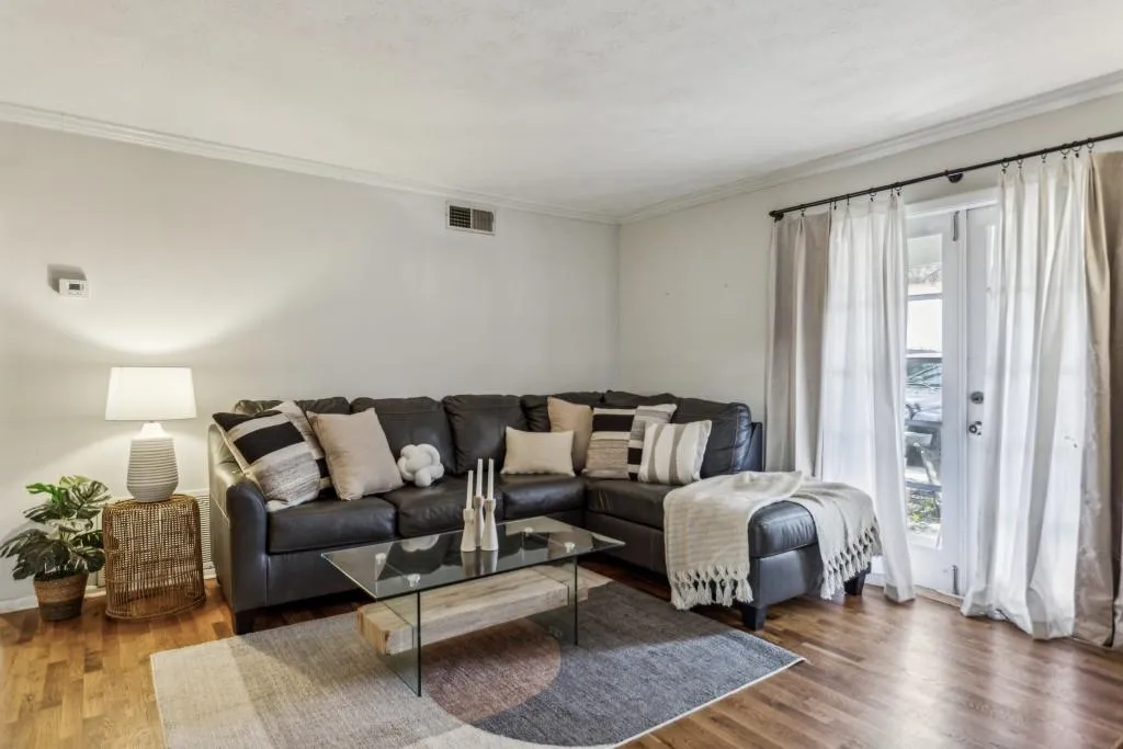 Expansive living room, boasting a charming fireplace perfect for cozy gatherings.