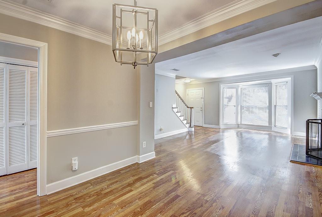 Unfurnished living room featuring crown molding and light hardwood / wood-style floors