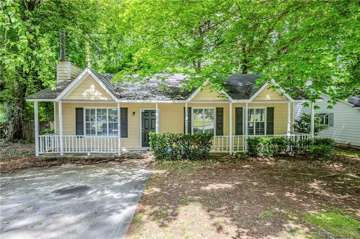 Ranch-style home with covered porch and a chimney