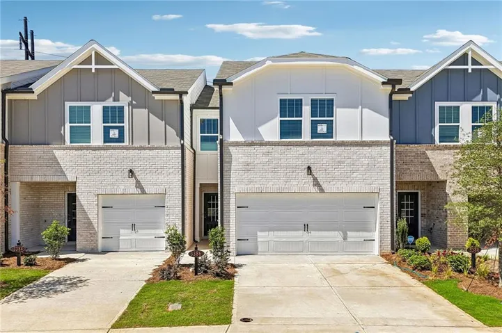 Contemporary exterior with white brick and board and batten siding