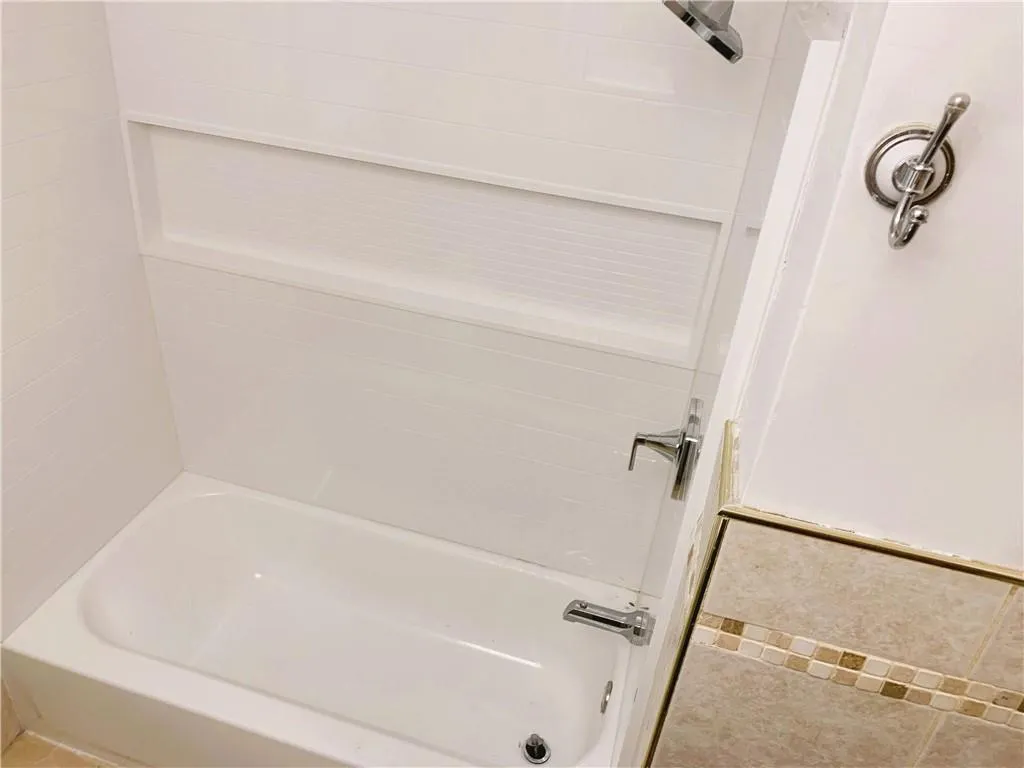 Full bath featuring bathing tub / shower combination