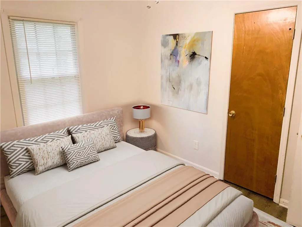 Bedroom with baseboards and wood finished floors