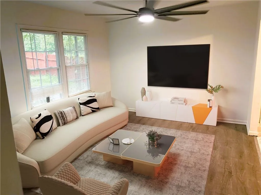 Living room featuring wood finished floors and a ceiling fan