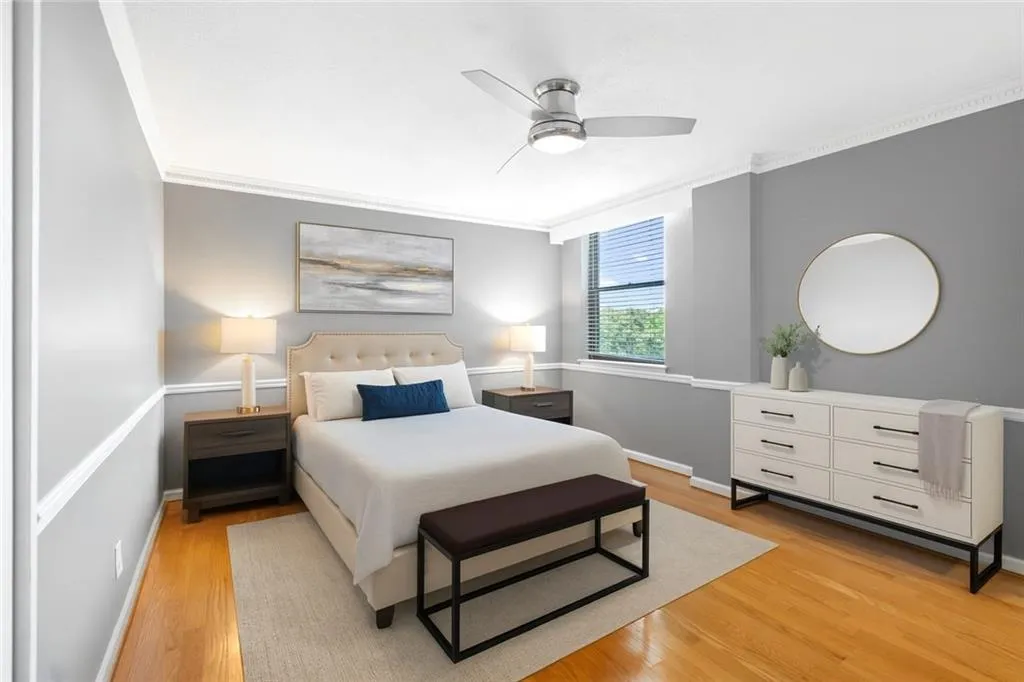 Virtually staged Bedroom with crown molding, light wood-style floors, and ceiling fan