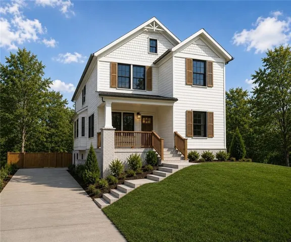 White siding exterior with multiple gables and dormer, covered front porch with white columns, brick foundation, wood railing and steps, and a concrete driveway