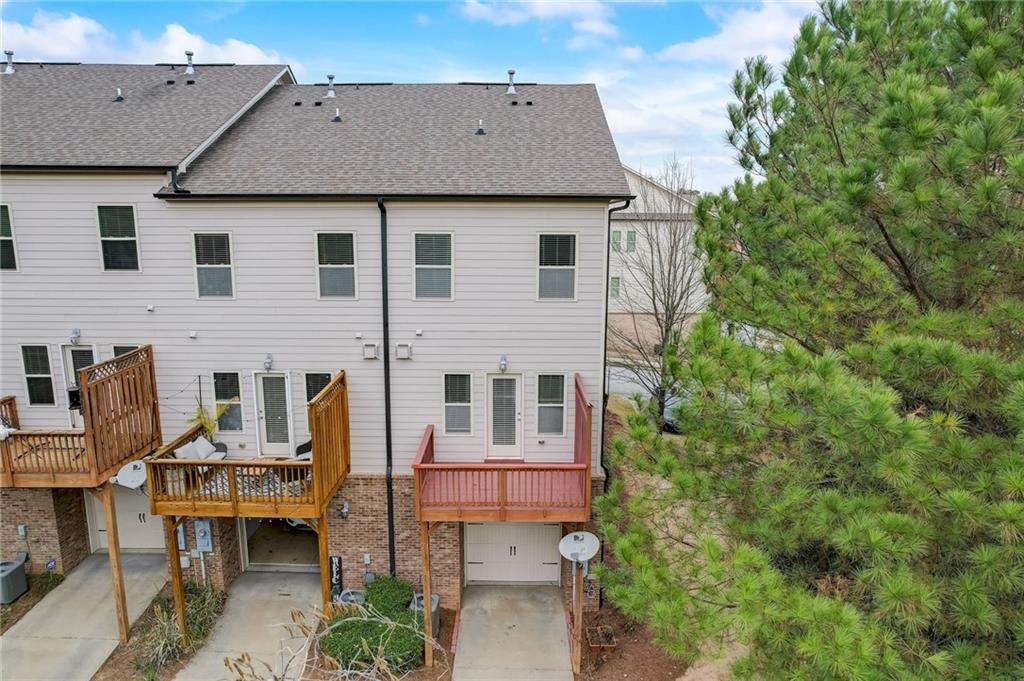 Back of house featuring a deck and central AC unit
