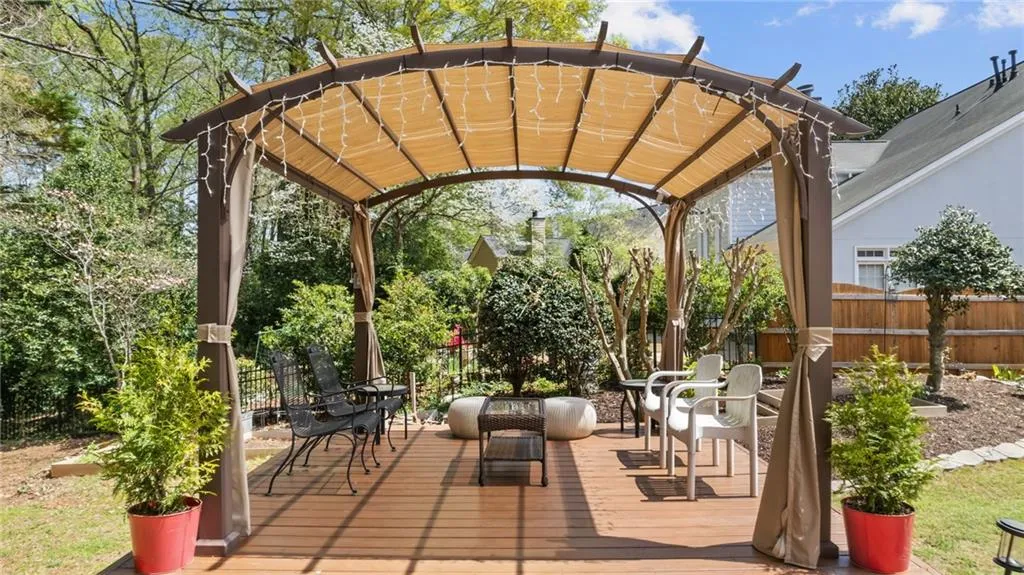 View of patio / terrace with a pergola, a deck, and fence