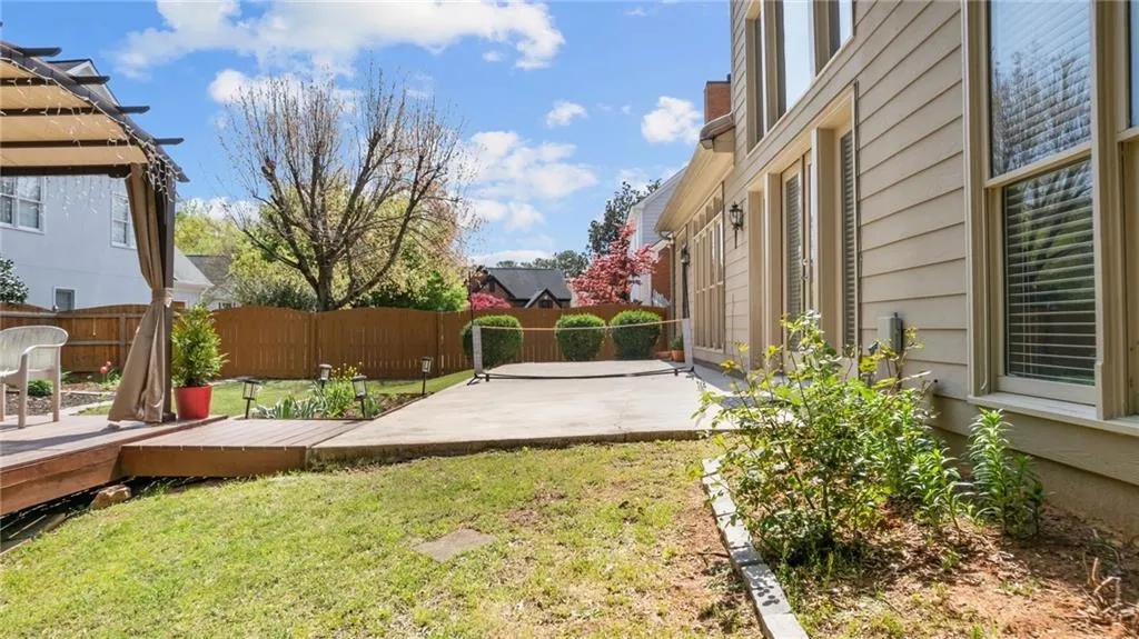 View of yard featuring a pergola, a deck, fence, and a patio area